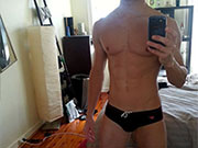 A collection of hot guys taking selfies in their black speedo swimwear.