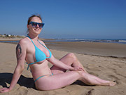 Redhead bikini model gets a little naughty on the beach