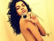Curly-haired Indian hottie is stripping and masturbating on cam