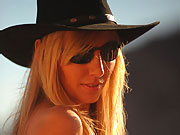 Hayley Marie Coppin outdoors in her black hat and sunglasses