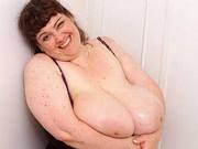 Fun-loving BBW lady having a shower while exposing her monstrous tits