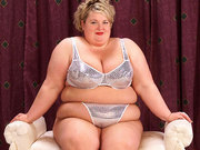 Super-sized BBW harlot showing her extremely large tits on her couch