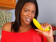 Pretty ebony chick with banana shows off her amazing thick butt in the kitchen