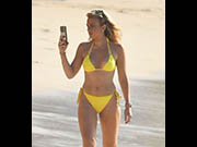 Tallia Storm in yellow bikini at Sandy Lane Hotelâ€™s Beach in Barbados